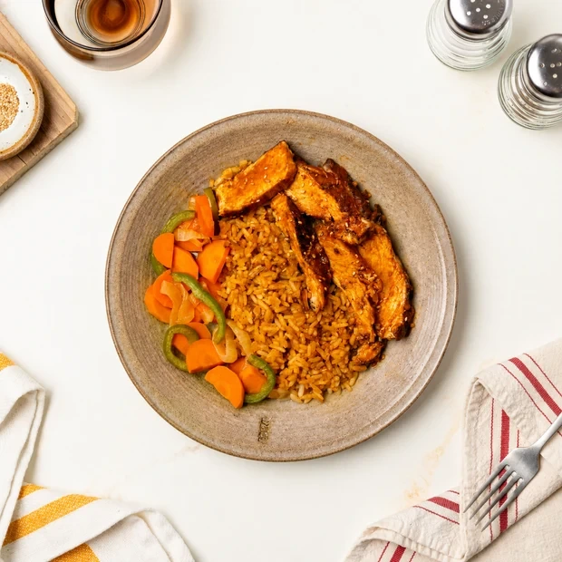 Plated Korean Ginger Chicken Bowl with seasoned rice and caramelized veggies