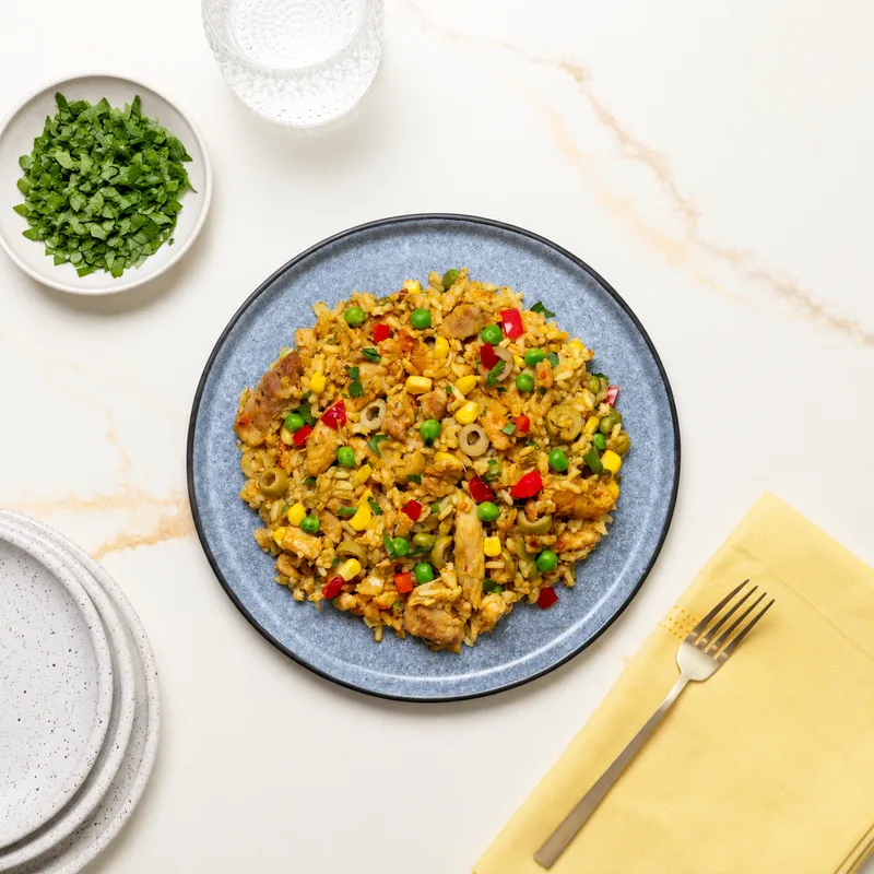 Spanish Arroz con Pollo: saffron rice with seasoned chicken, peas, peppers and olives