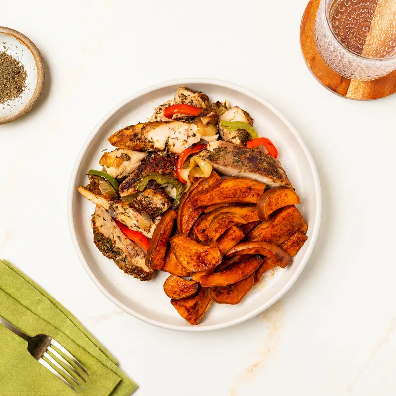 Jerk Chicken with Sweet Potatoes and Peppers on a white plate
